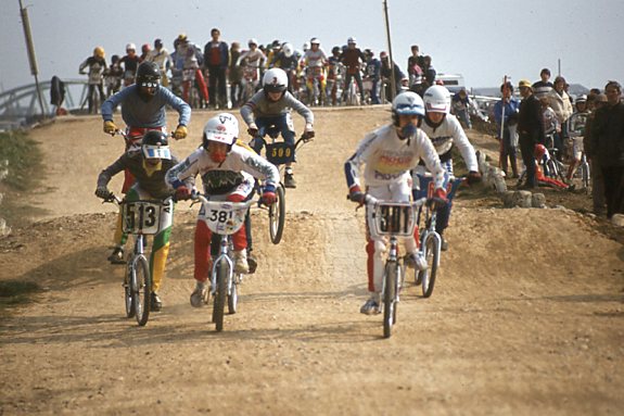 Young riders racing BMX bikes on a dirt track in 1984, during the 1980s BMX boom