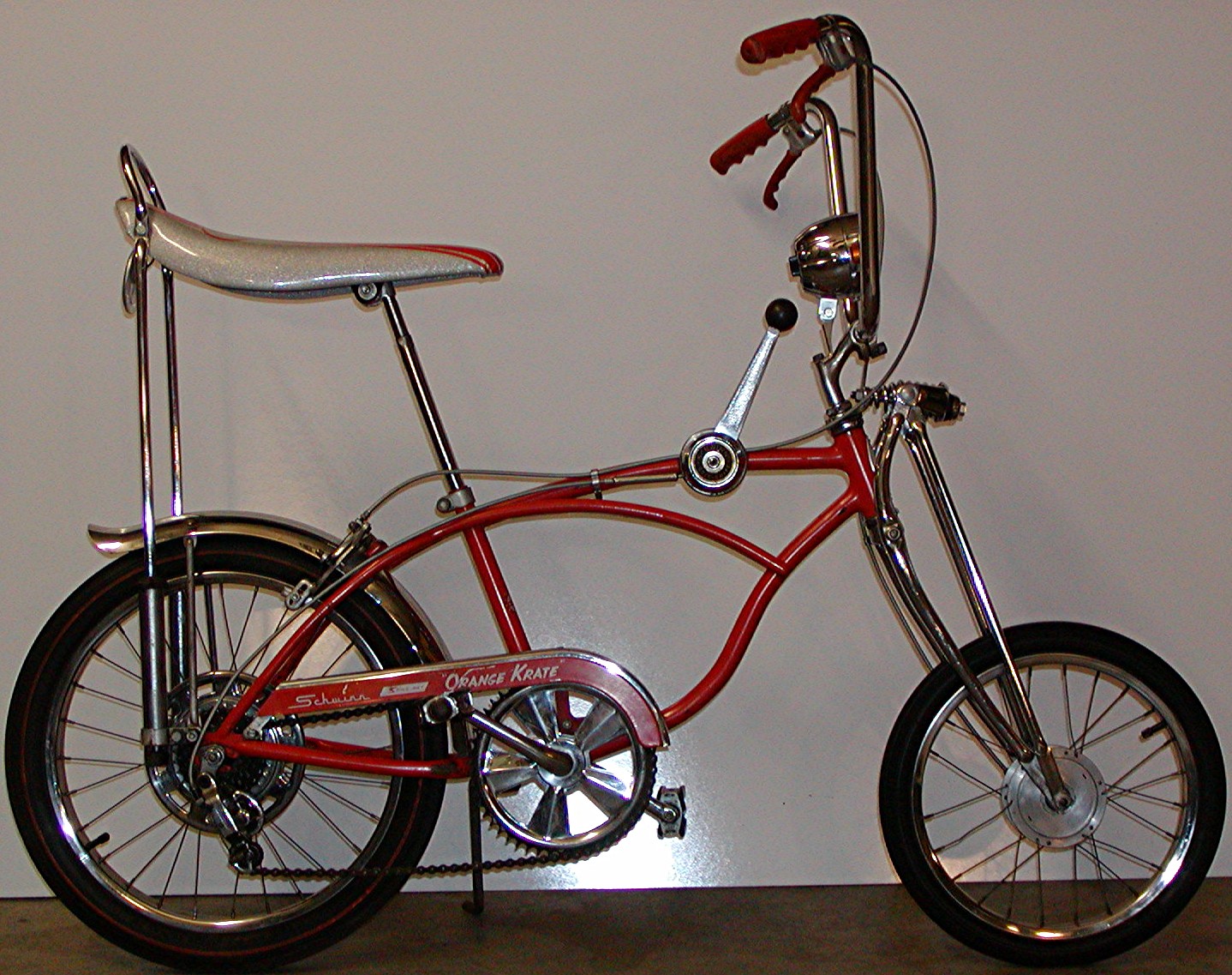 Orange 1968 Schwinn Sting-Ray Orange Krate bicycle with a banana seat and high-rise handlebars, the kind of bike early BMX riders raced on dirt tracks
